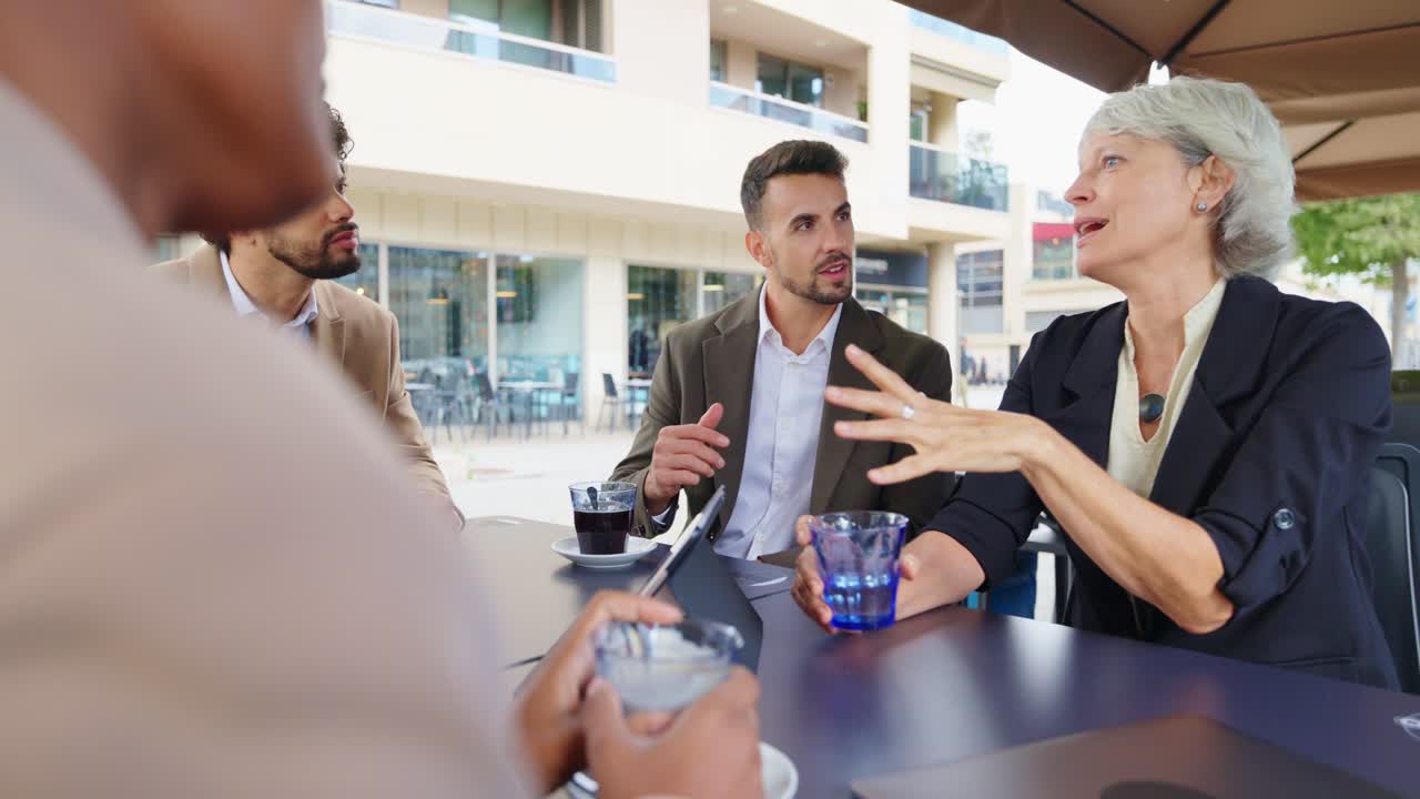 Group of business people meeting at an outdoor cafe