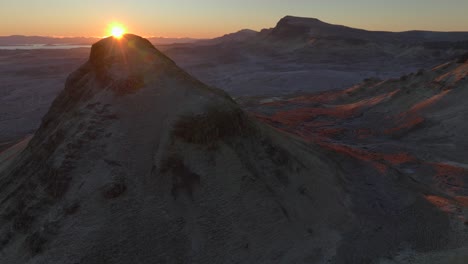 Slow-reveal-of-sunrise-over-top-of-Scottish-landslip-mountain-with-Trotternish-Ridge-visible-over-winter-moorland