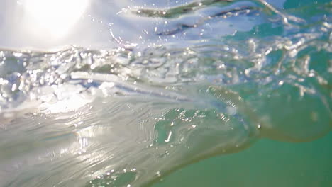 blue water from ocean swell splashing onto camera lens in summer