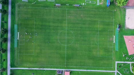 an aerial view of the soccer field, on which the soccer players are currently moving and playing