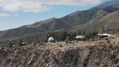 Small-village-in-Amaicha-del-Valle-with-scenic-mountain-landscape-aerial-view