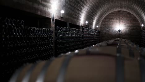 luxury underground wine cellar, dark wine cellar with dim lighting and wine barrels in the middle of the room