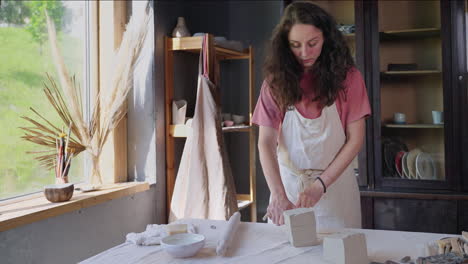 woman working with clay in a pottery studio