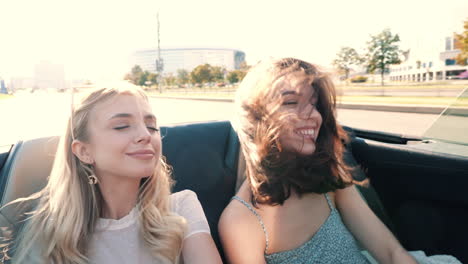 two friends enjoying a road trip in a convertible