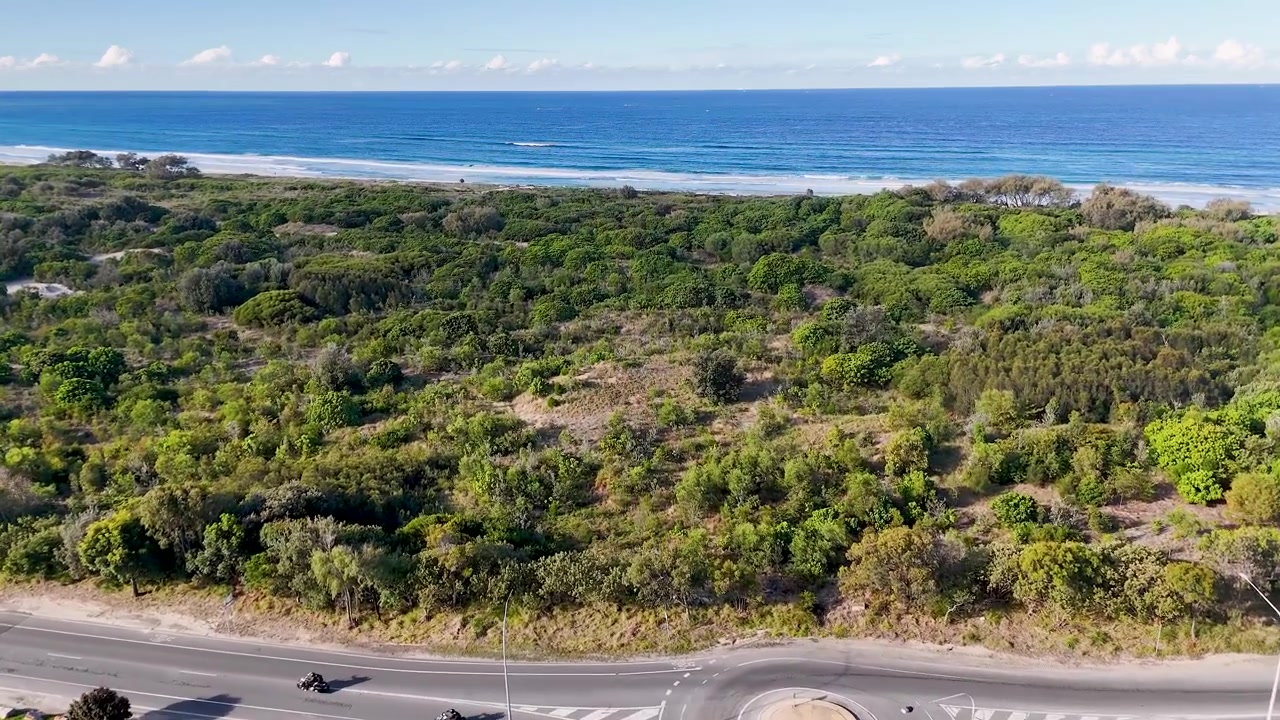 Ripresa drone del traffico su una rotonda costiera vicino al mare a Main Beach, Australia.