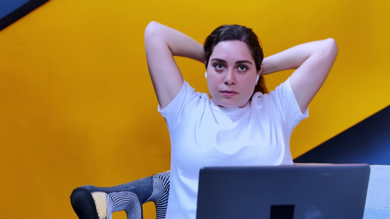 Relaxed woman working on laptop at home office