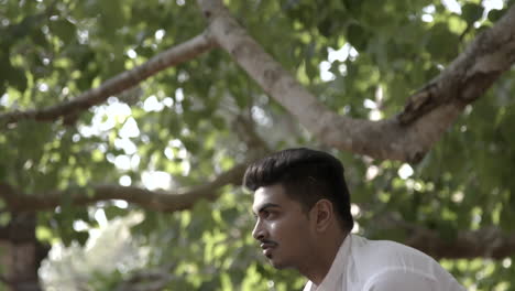 Young,-handsome-Indian-man-does-yoga-in-front-of-temples