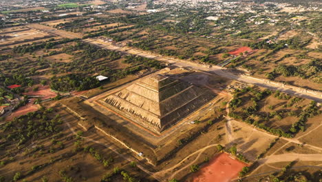 aerial view tilting away from the pyramid of the sun, in sunny teotihuacan, mexico