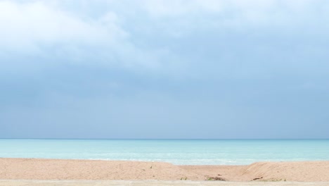 view of the beautiful waters of the sea from the beach on a cloudy day