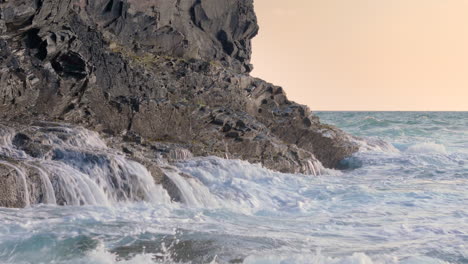 waves crashing against rugged coastal cliffs