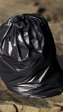 a black trash bag on the ground