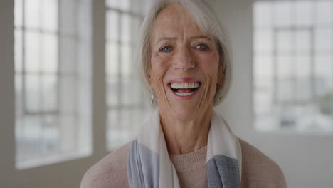 portrait of middle aged woman laughing happy enjoying retirement satisfaction in apartment elderly caucasian female wearing scarf