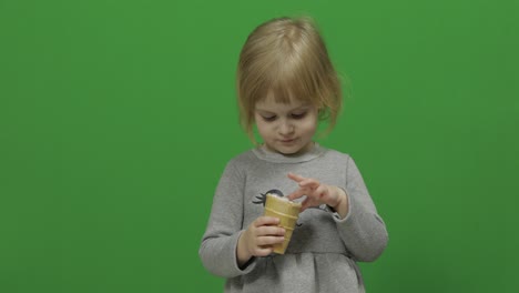 Kid-girl-eat-ice-cream-on-a-Green-Screen,-Chroma-Key