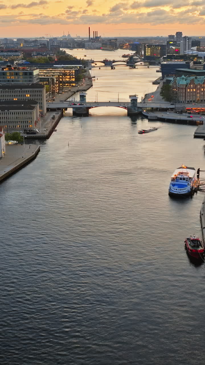 Aerial drone view of Borsen historical place in Copenhagen, Denmark at night. Vertical