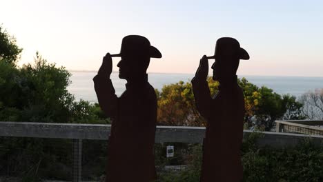 silhouettes of soldiers overlooking the ocean