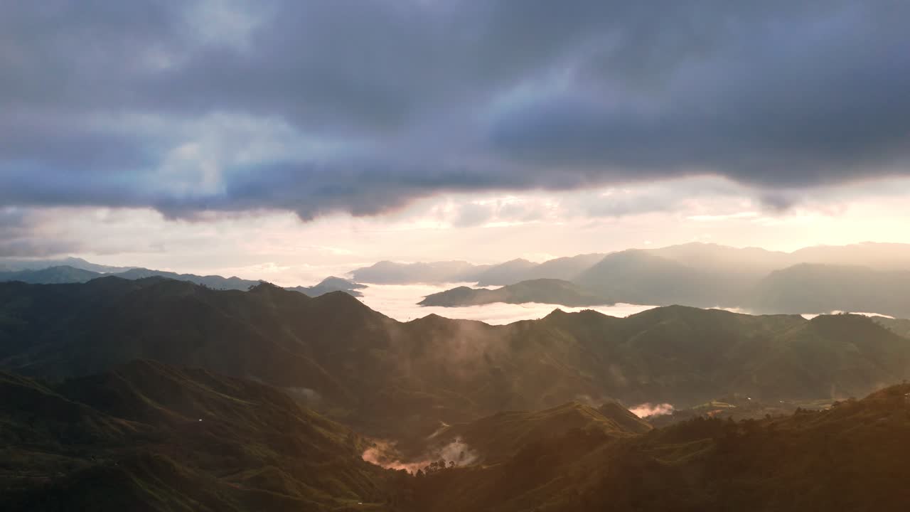 Breathtaking aerial drone footage of misty mountain peaks at sunrise in the Philippines. Ideal for travel, nature, cinematic, and inspirational projects