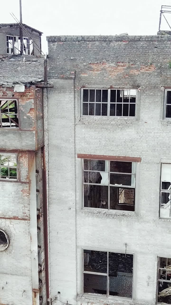 Abandoned industrial building. Aerial view.. Vertical video