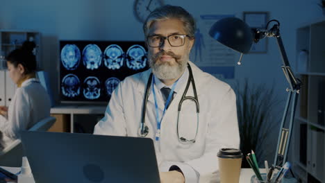 doctor working late at night in a hospital office.