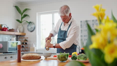 senior man cooking in kitchen