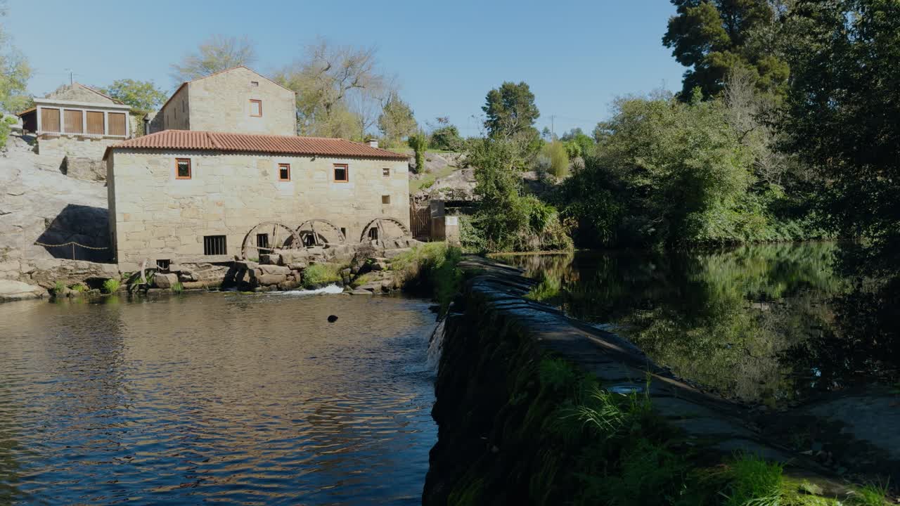 Panning shot of the location of the big watermill on the Cavado river in north Portugal