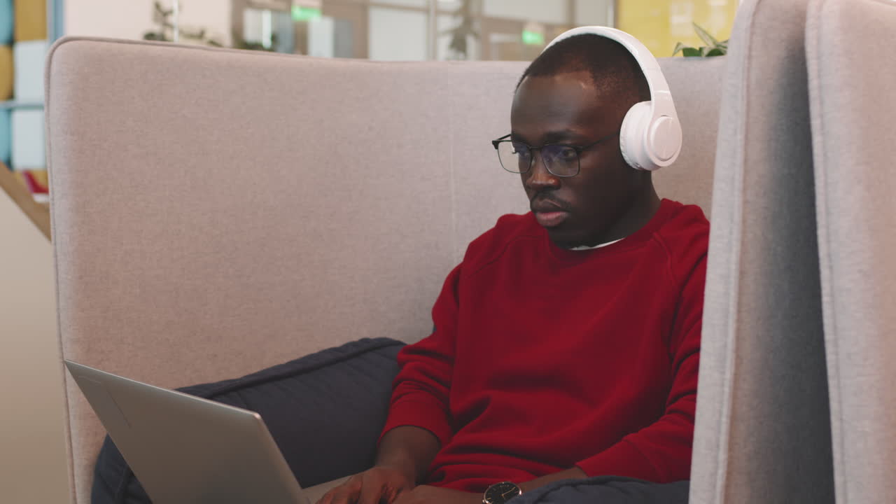 African-American Man Working on Laptop in Coworking Space