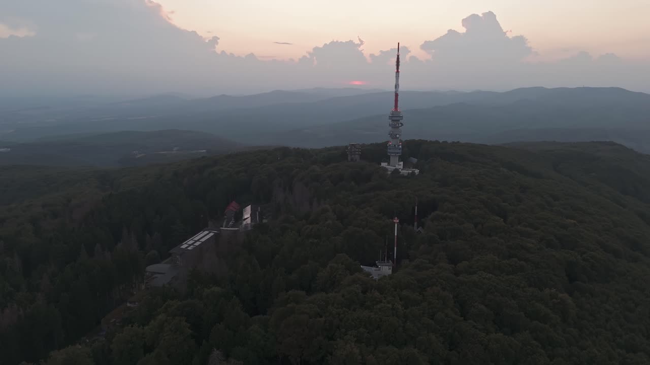 Orbital aerial view around Kékestető with the TV Tower and the nursing home inside the forested Mátra Mountains in Hungary