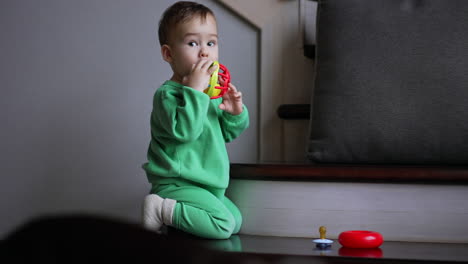 baby playing with a toy on stairs