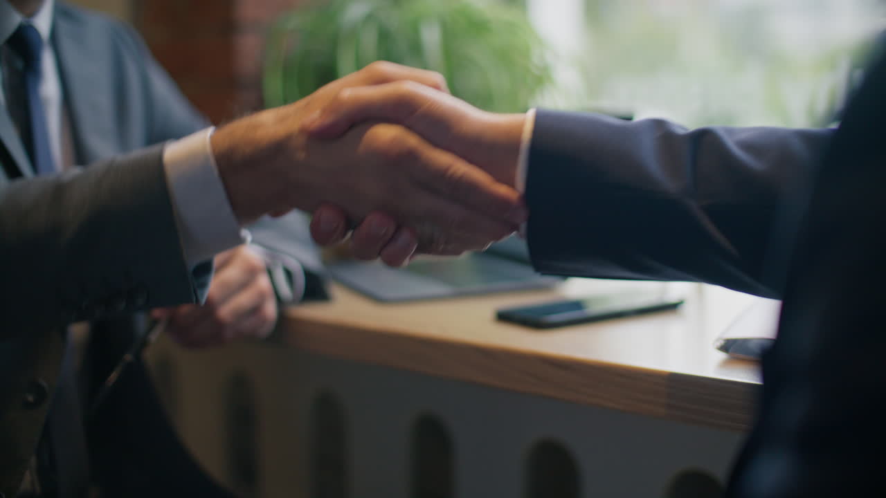 Handshake Between Two Businessmen Sealing Deal in Cafe