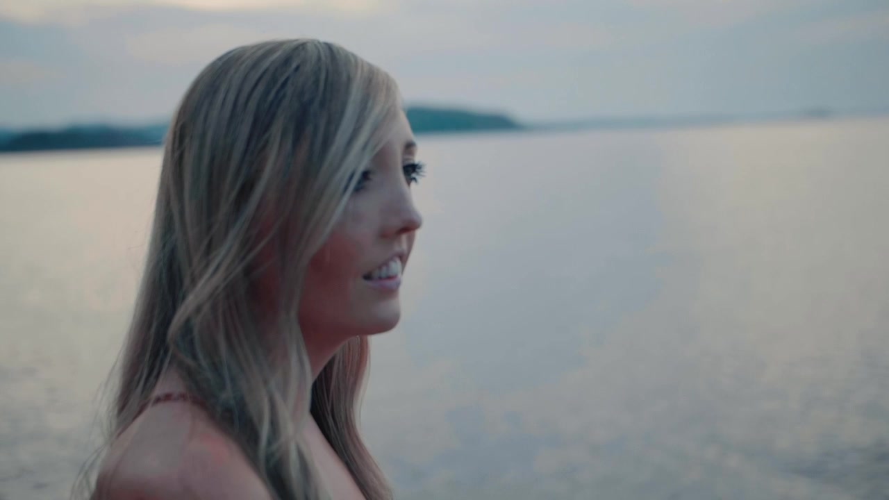 Profile of a Young Woman Looking Out Over a Calm Lake