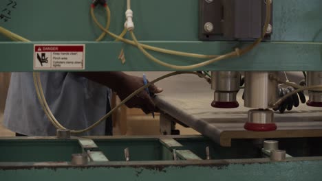 cabinet maker measures a kitchen countertop for cutting in an industrial factory