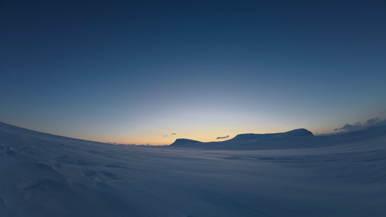 Snowy blue hour time lapse: Snow and clouds drift in cold winter scene