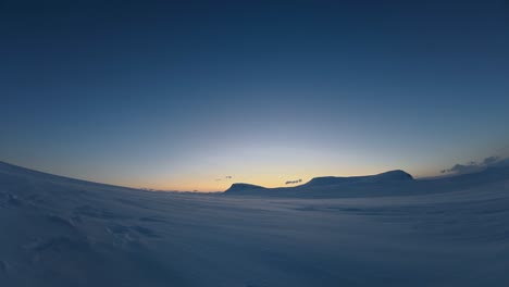 snowy blue hour time lapse: snow and clouds drift in cold winter scene