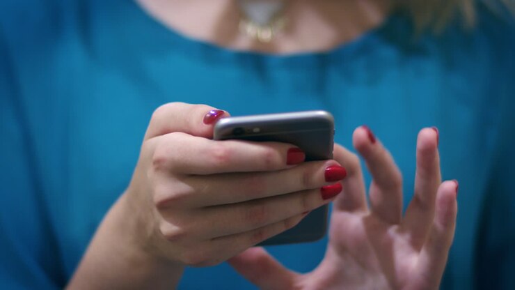 Woman hand typing mobile message on screen smartphone