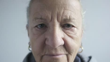 elder senior retired woman remove glasses close up portrait in slow motion