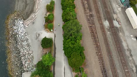 Overhead-aerial-view-of-a-cyclist-riding-on-the-Elliott-Bay-Trail-in-downtown-Seattle