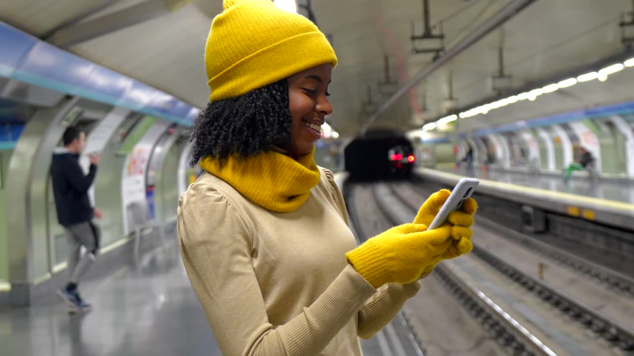 Woman using phone at subway station