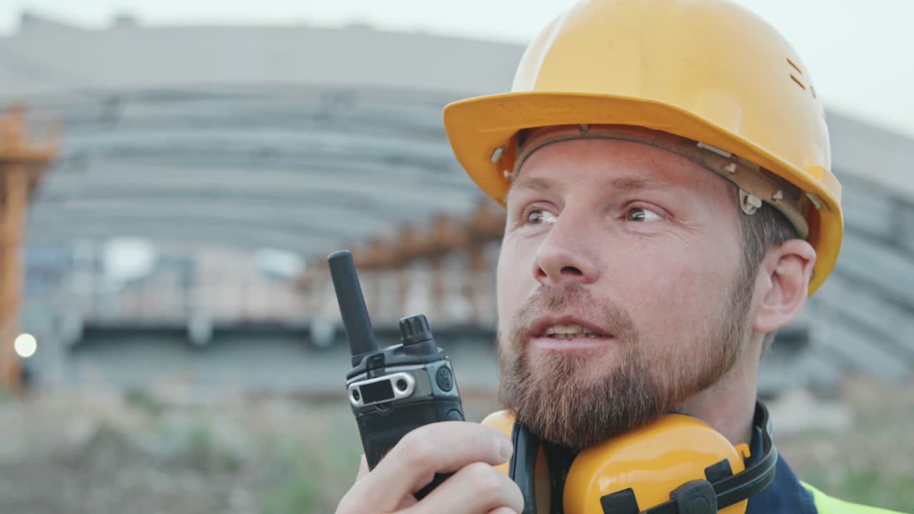 Close Up of Foreman Talking Into Walkie-Talkie
