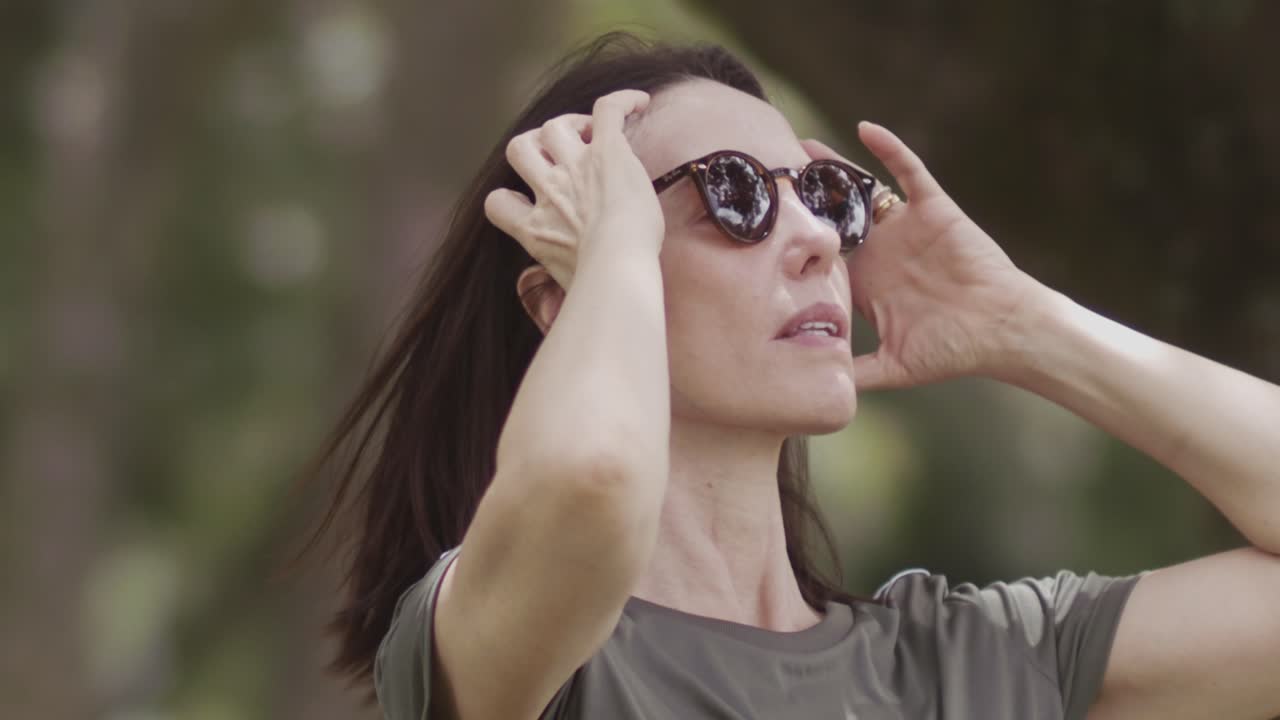 Slow motion, brunette beautiful woman, flowing hair, sunglasses