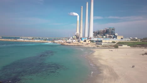 aerial shot of the hadera desalination plant, israel, over the beach and water