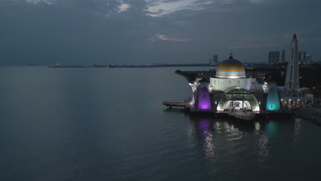 colorful rainbow mosque looks out onto pulau panjang bay melaka malaysia