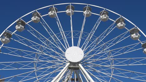 ferris wheel in action againts a blue sly.