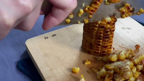 Removing kernels from the corncob at home kitchen, Tokyo, Japan