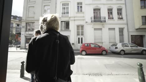 2 people exiting a building out of focus.