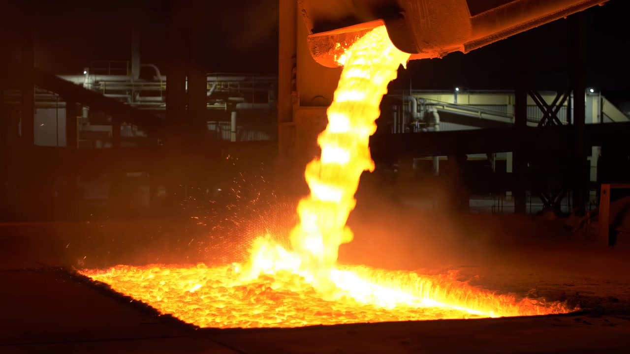 Molten Steel Pouring Into Glowing Pit, Ladle Release In Night Foundry With Intense Orange Flow, Sparks