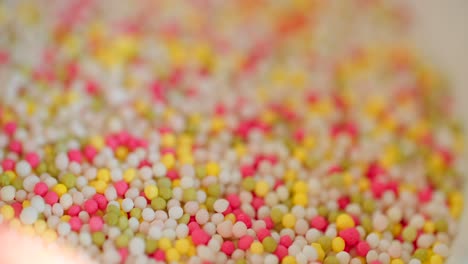 close-up view of bowl with colorful sugar sprinkles dots for decoration for cake and pastry