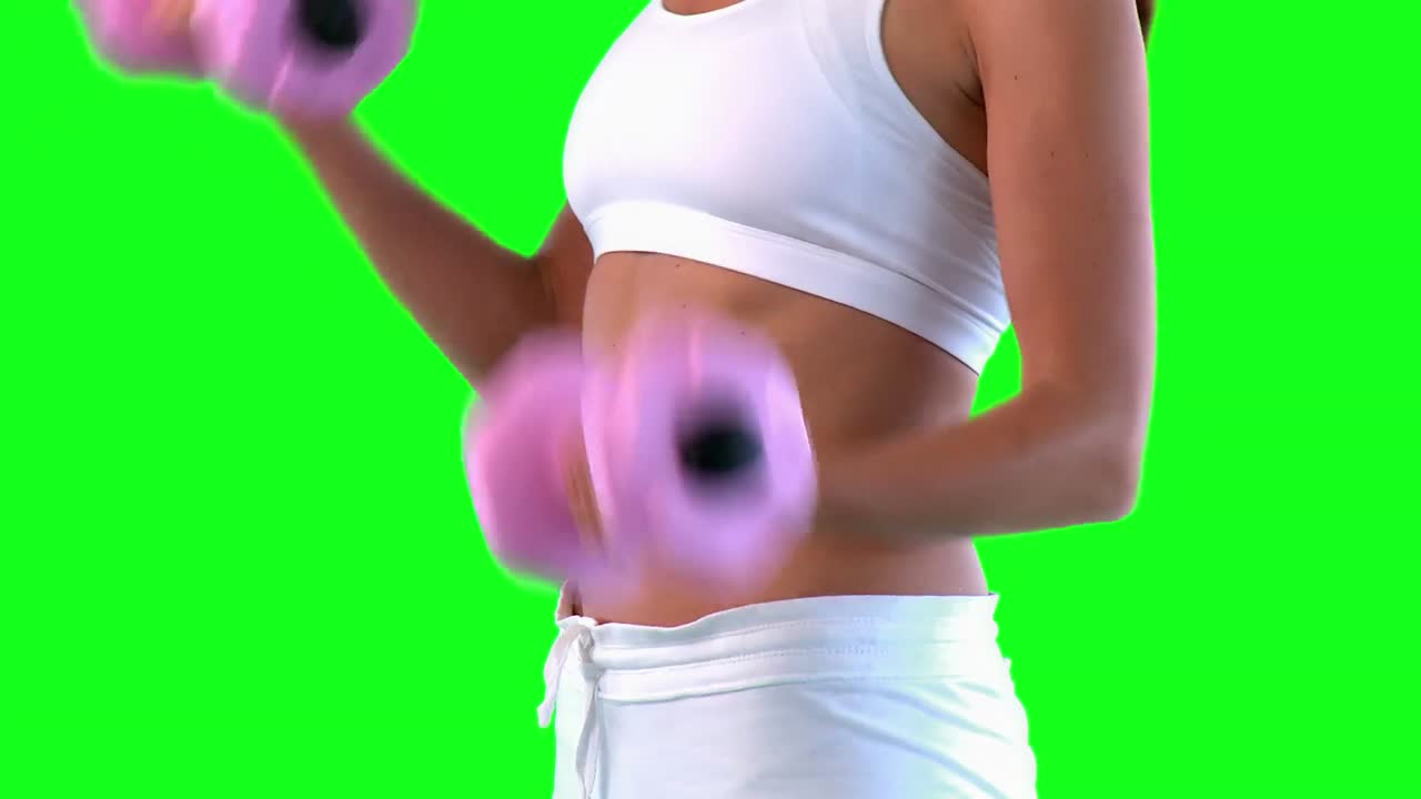 Attractive woman holding dumbells 