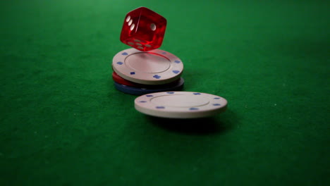 red dice and chips falling on casino table