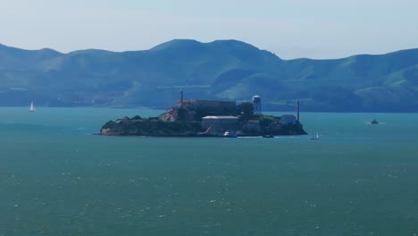 Static-drone-shot-of-Alcatraz-Island-during-a-windy-day-in-the-San-Francisco-Bay