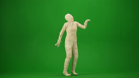 a mummy wrapped in bandages dancing waving hands and legs green screen isolated chroma key video - a mummy wrapped in bandages dancing, waving hands and legs. green screen isolated chroma key video. mock up, workspace, advertisement. full length. side view. halloween holidays