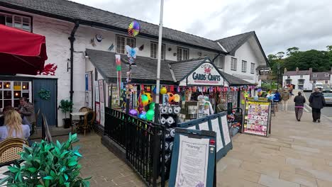 shops, vehicles, and pedestrians in lively street